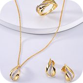 Conjunto de colar, anel e brincos dourados com detalhes em zircônias, sobre fundo branco.